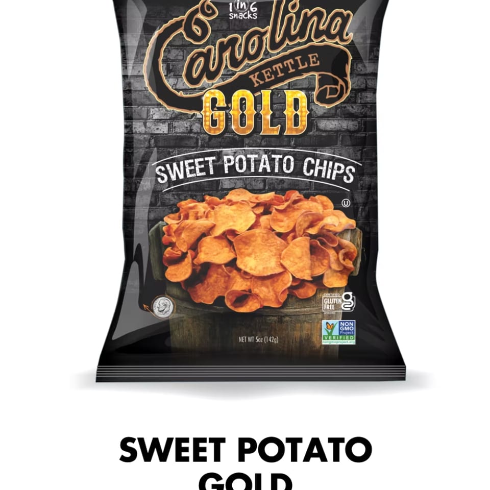 A black bag of Carolina Kettle Gold Sweet Potato Chips with a bowl of chips on the front.