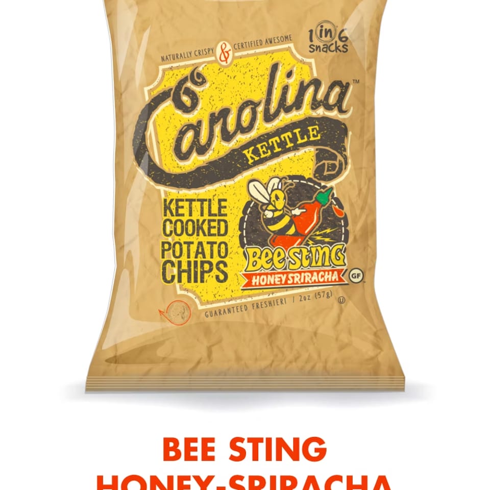 A bag of Carolina Kettle Bee Sting Honey Sriracha potato chips.